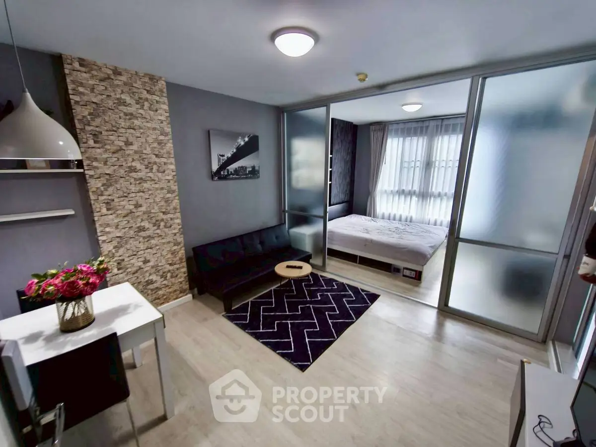 Modern studio apartment with stylish decor and open layout, featuring a cozy living area and bedroom.