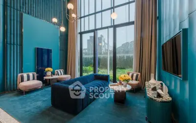 Luxurious living room with high ceilings and modern decor, featuring a stunning view through large windows.