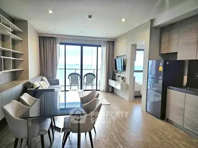Modern open-plan living room with dining area and balcony view