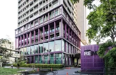 Modern urban building with striking purple facade and lush greenery, ideal for contemporary living.