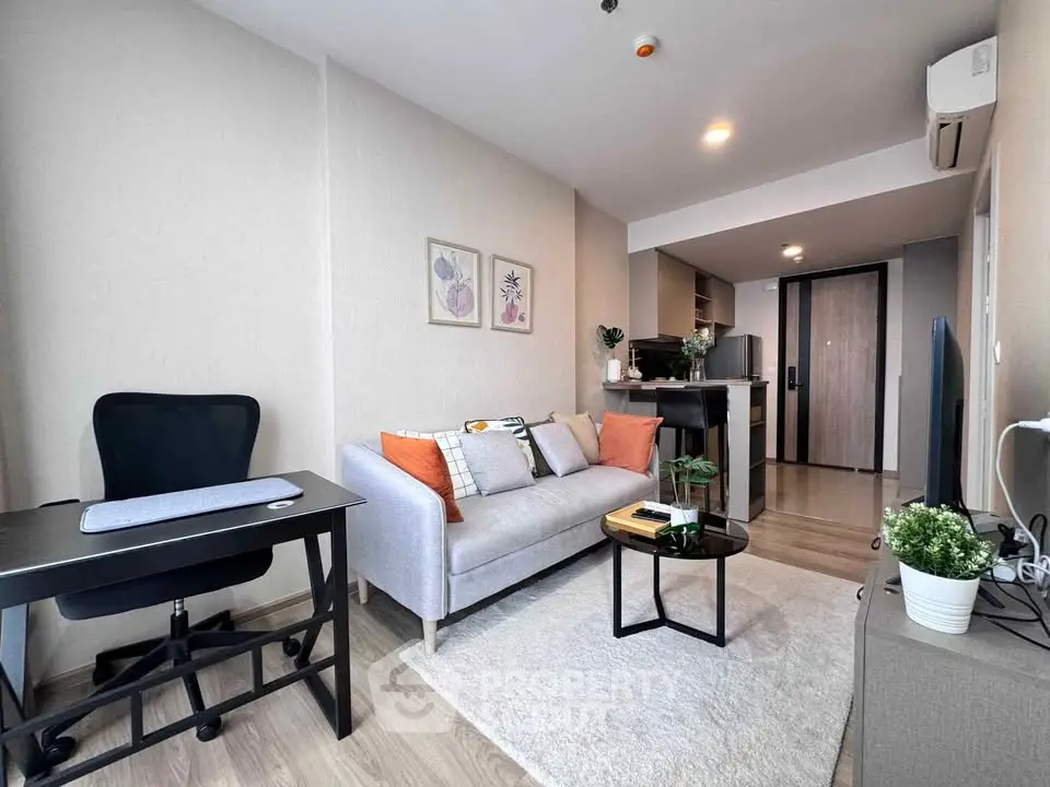Modern living room with cozy sofa, stylish decor, and open kitchen layout in a contemporary apartment.