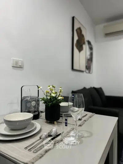 Modern dining setup in stylish living room with elegant decor and cozy ambiance.