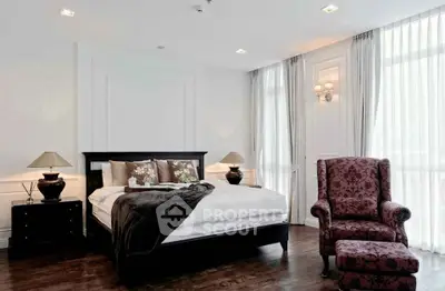 Luxurious bedroom with elegant decor and large windows for natural light.