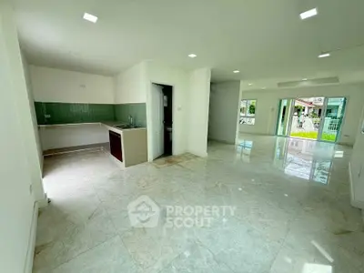Spacious open-plan living area with modern kitchen and garden view