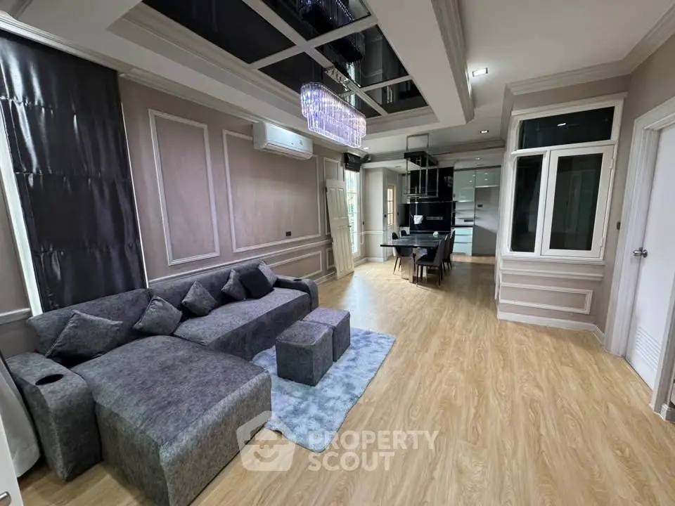 Luxurious living room with elegant decor and modern kitchen in open layout