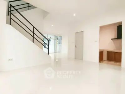 Spacious modern living room with sleek staircase and open layout
