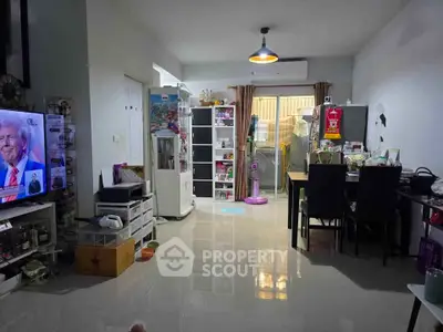 Spacious living room with modern decor and ample natural light, perfect for family gatherings.