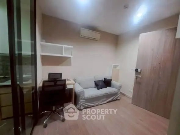 Cozy study room with sofa and desk in modern apartment