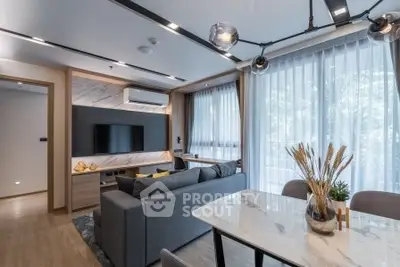 Modern living room with stylish decor and large windows in a contemporary apartment.