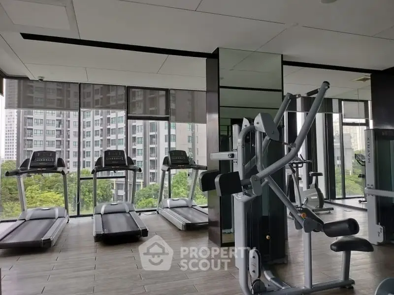 Modern gym with city view and state-of-the-art fitness equipment