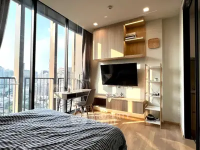 Modern bedroom with city view, large windows, and stylish furniture in a high-rise apartment.