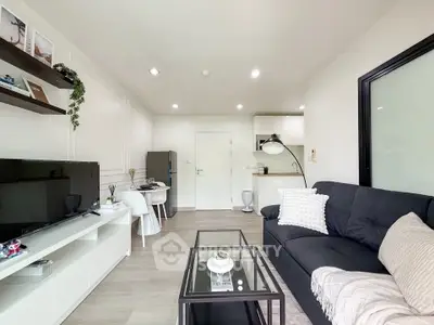 Modern living room with sleek furniture and open kitchen layout