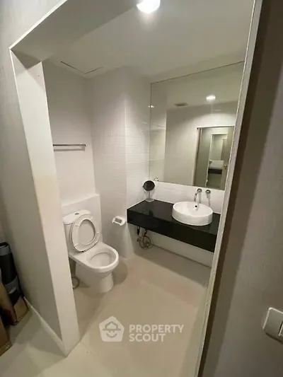 Modern bathroom with sleek fixtures and large mirror