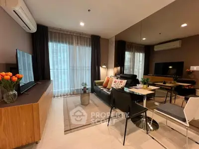 Modern living room with stylish decor, large windows, and cozy seating area in a contemporary apartment.