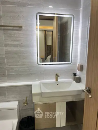 Modern bathroom with sleek design and illuminated mirror