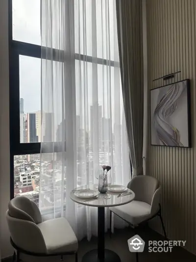 Chic dining nook with city view, modern decor, and elegant seating