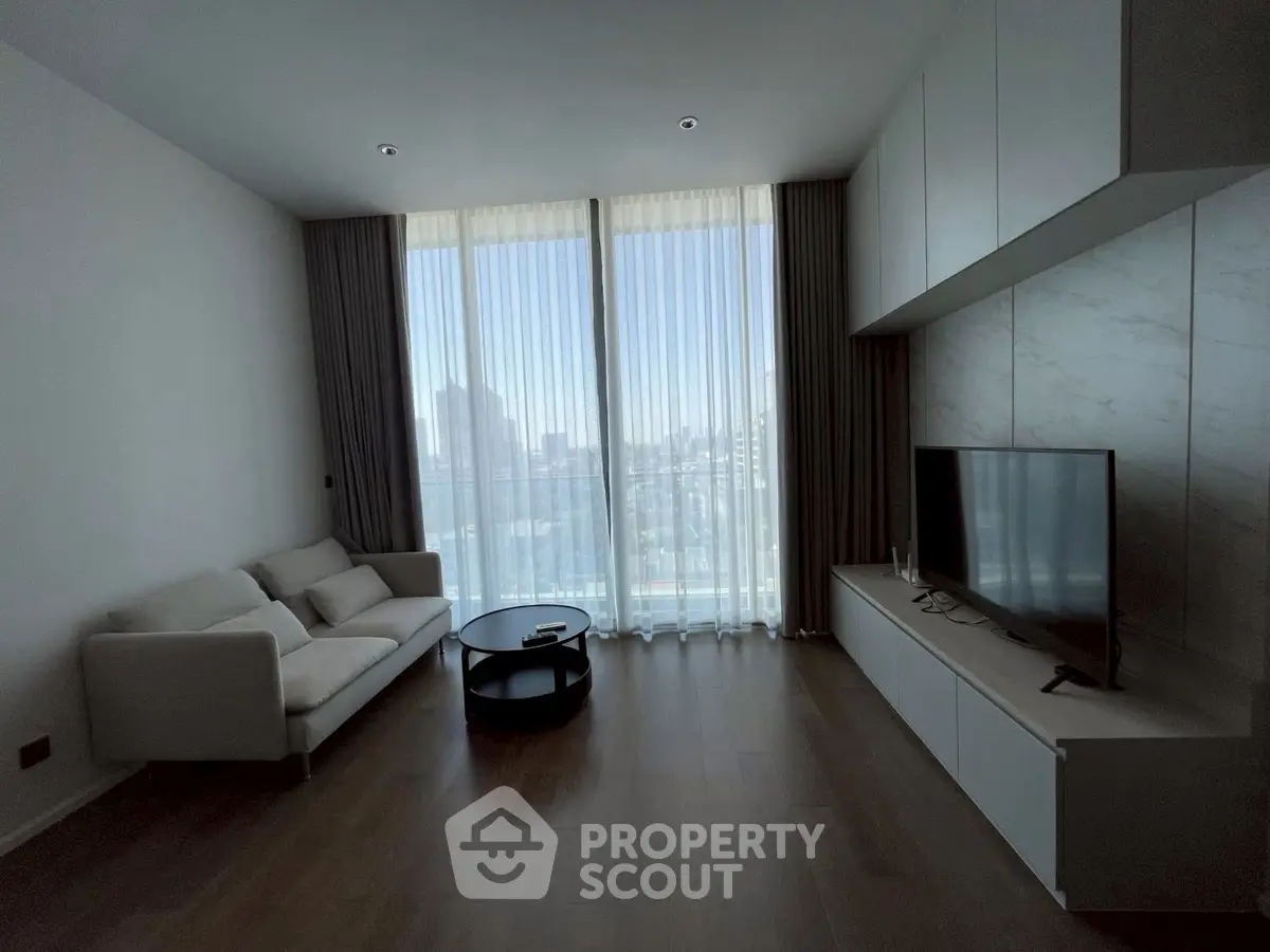 Modern living room with floor-to-ceiling windows and sleek furniture