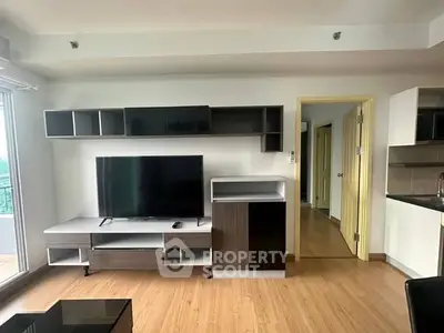 Modern living room with sleek TV unit and open layout in a stylish apartment.