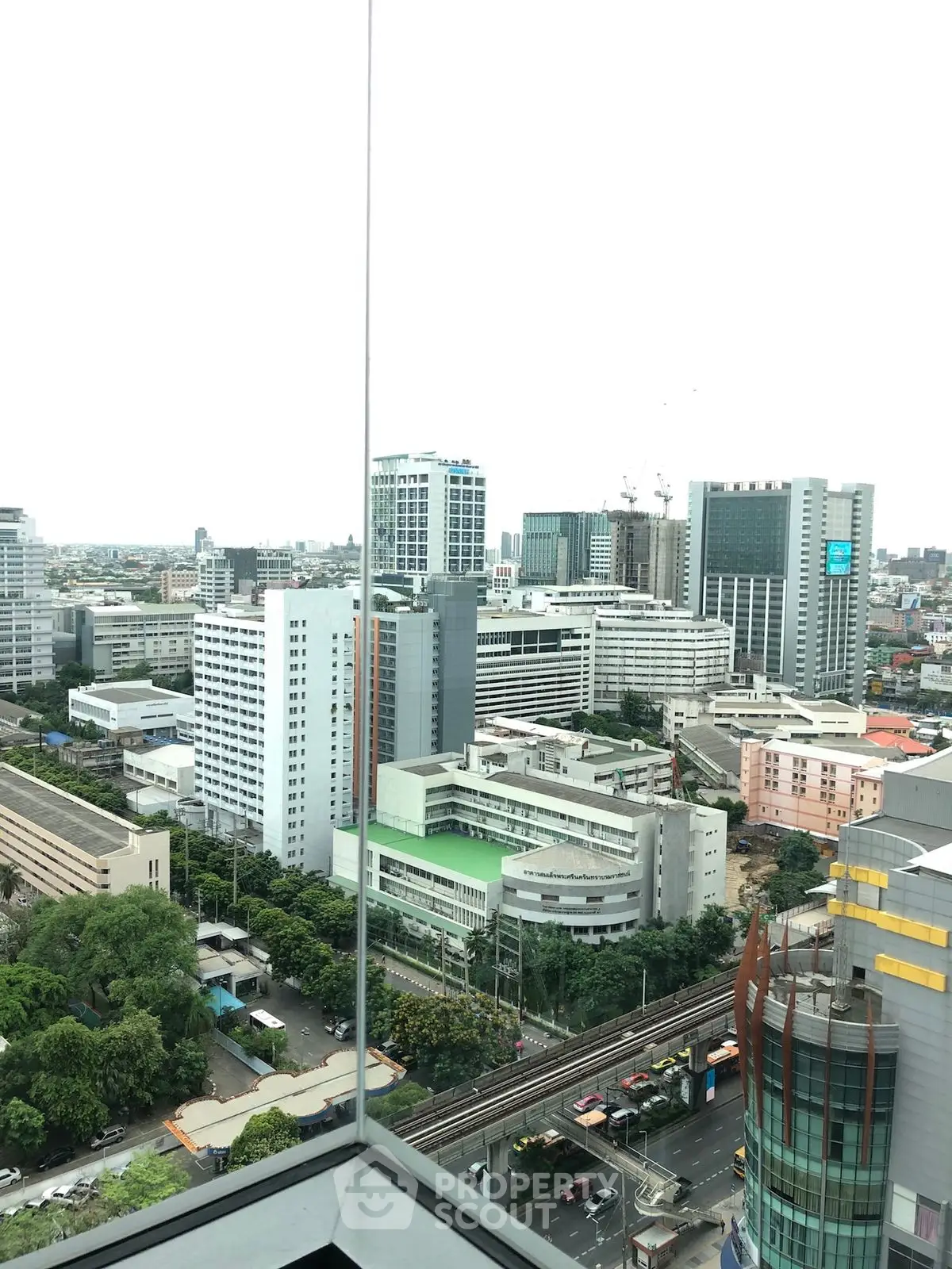 Stunning cityscape view from a high-rise building showcasing urban architecture and vibrant city life.