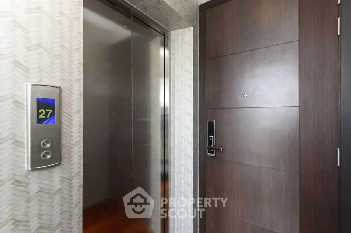 Modern apartment entrance with sleek elevator and stylish wooden door