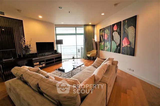 Spacious living room with modern decor and large windows offering a stunning view.