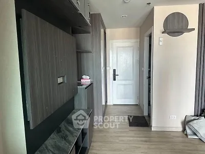 Modern apartment hallway with sleek wooden finishes and white door