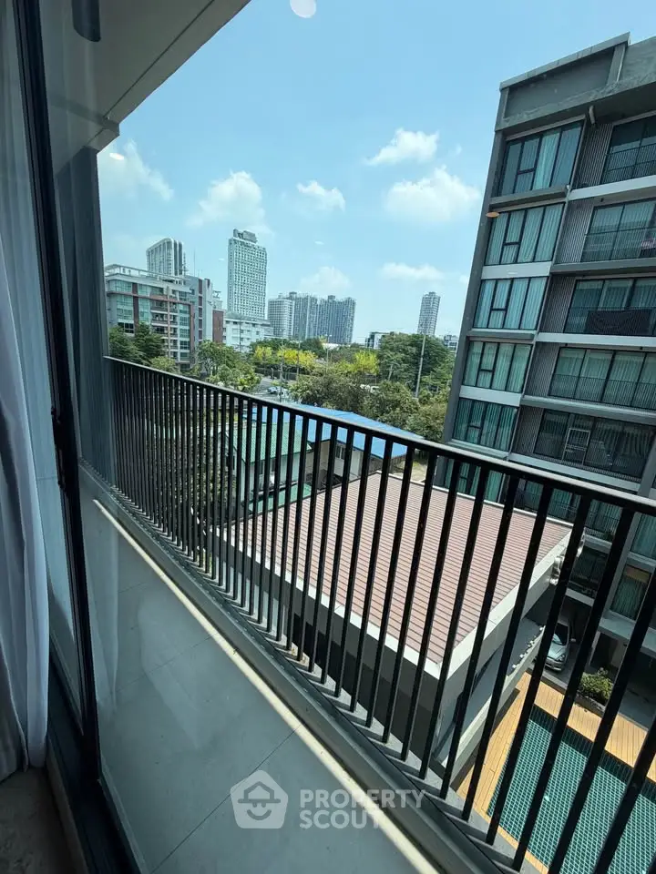 Spacious balcony with stunning city view in modern apartment building