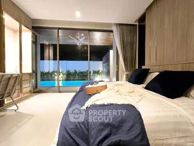 Luxurious bedroom with pool view and elegant decor in modern home