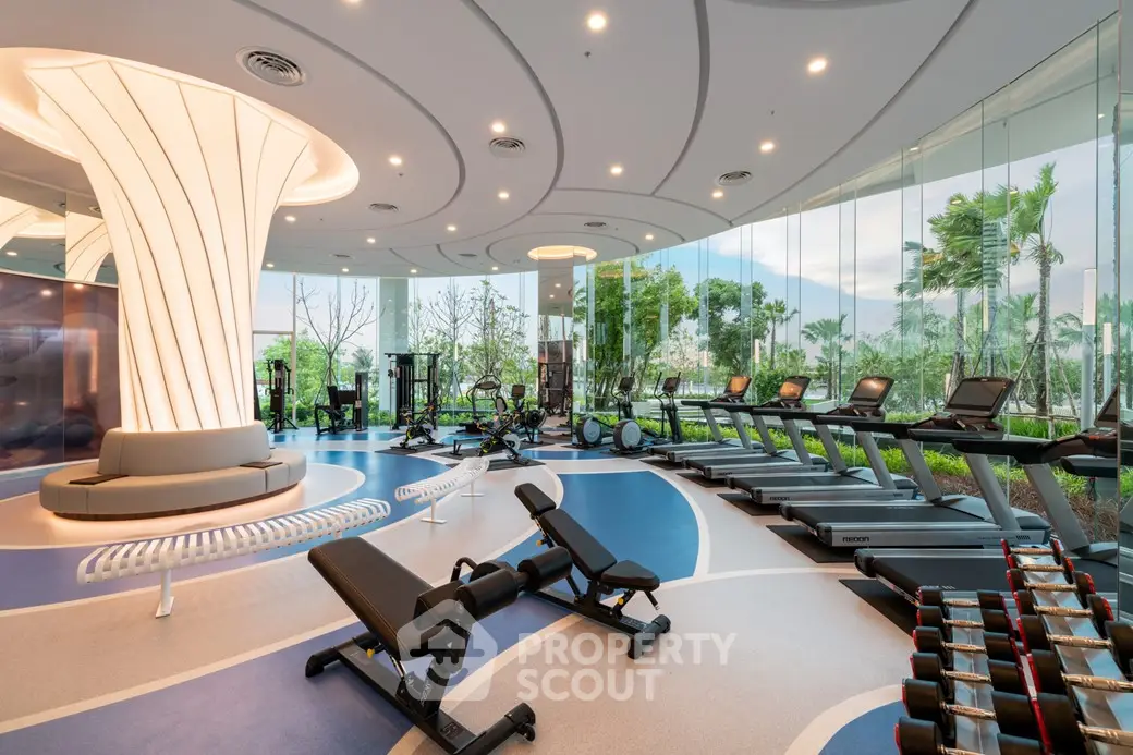 Luxurious modern gym with panoramic windows and state-of-the-art equipment in a high-end residential complex.