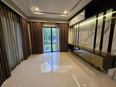 Spacious modern living room with floor-to-ceiling windows and elegant marble accents.