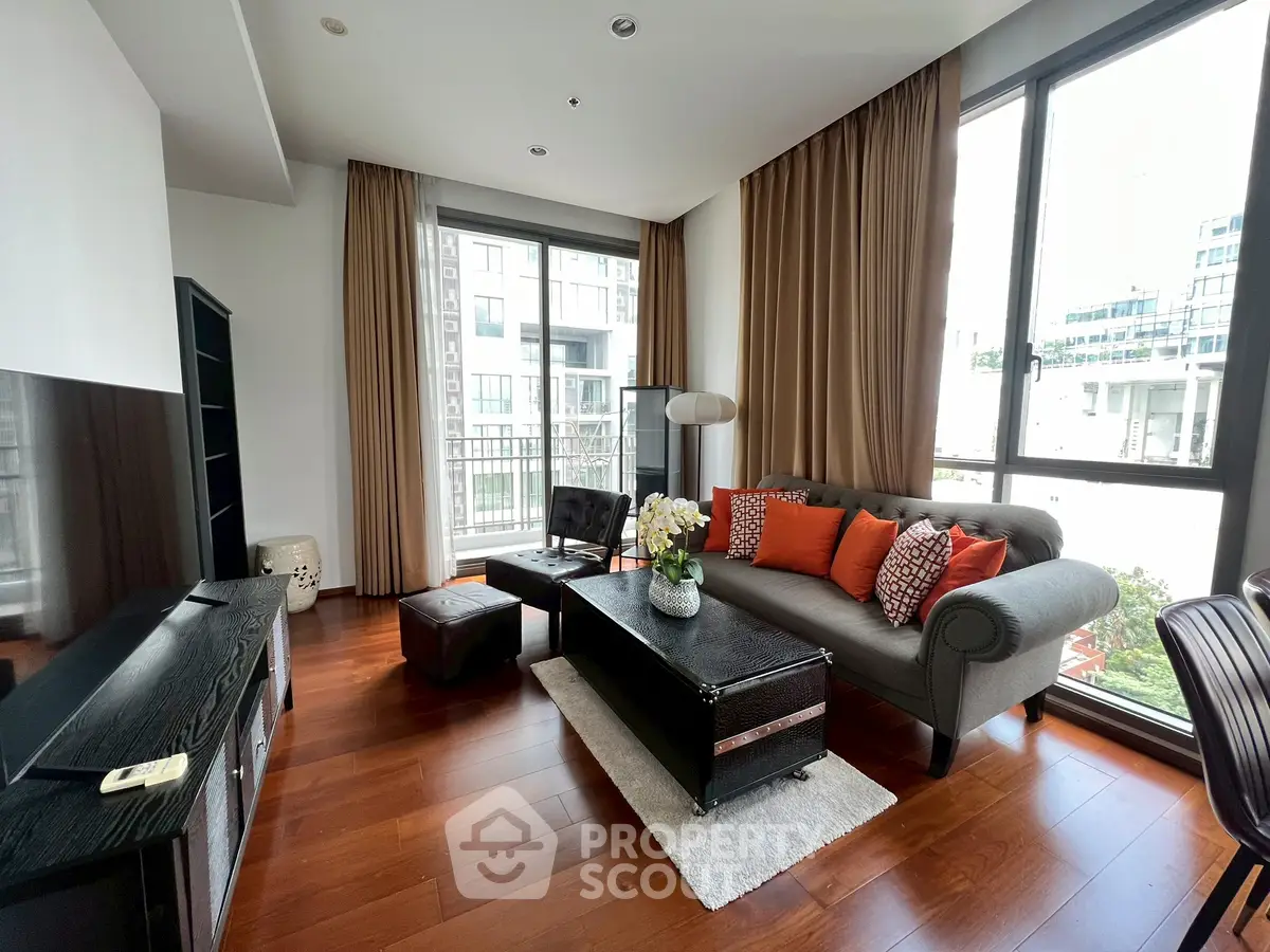Spacious living room with elegant decor and large windows offering abundant natural light.
