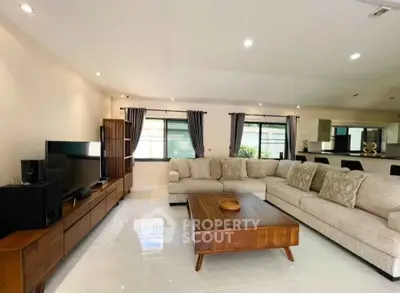 Spacious modern living room with elegant furniture and open layout, perfect for family gatherings.