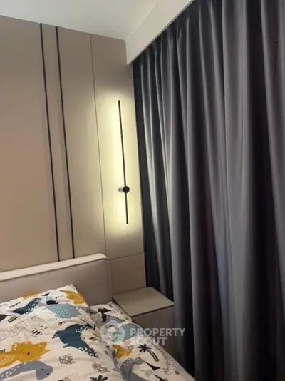 Modern bedroom with stylish lighting and elegant curtains