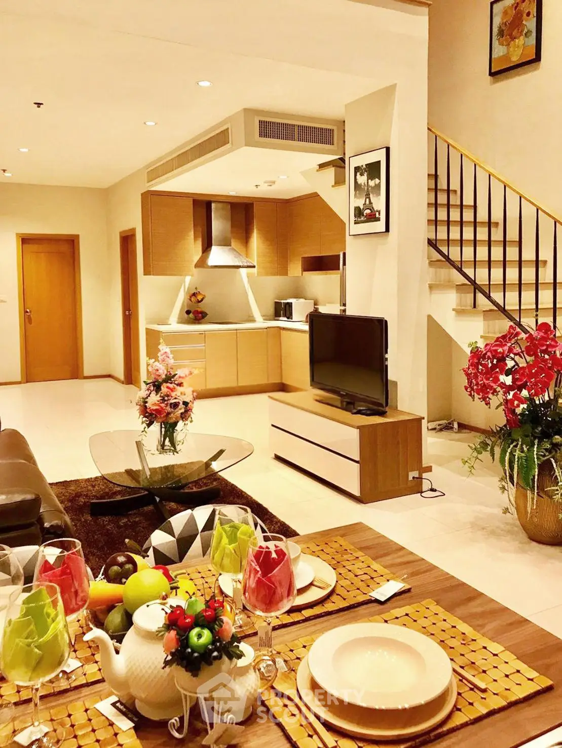 Luxurious open-plan living room with modern kitchen and elegant dining area, perfect for entertaining.