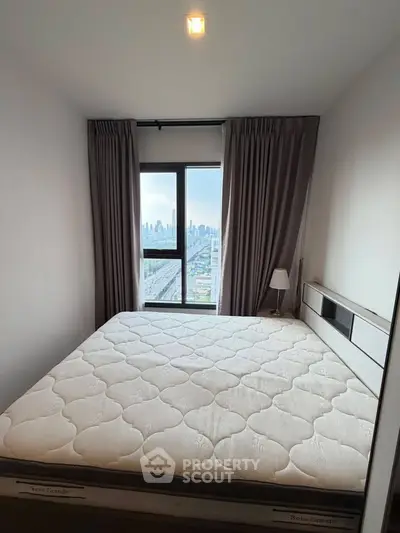 Modern bedroom with city view and large window, featuring a comfortable bed and elegant curtains.