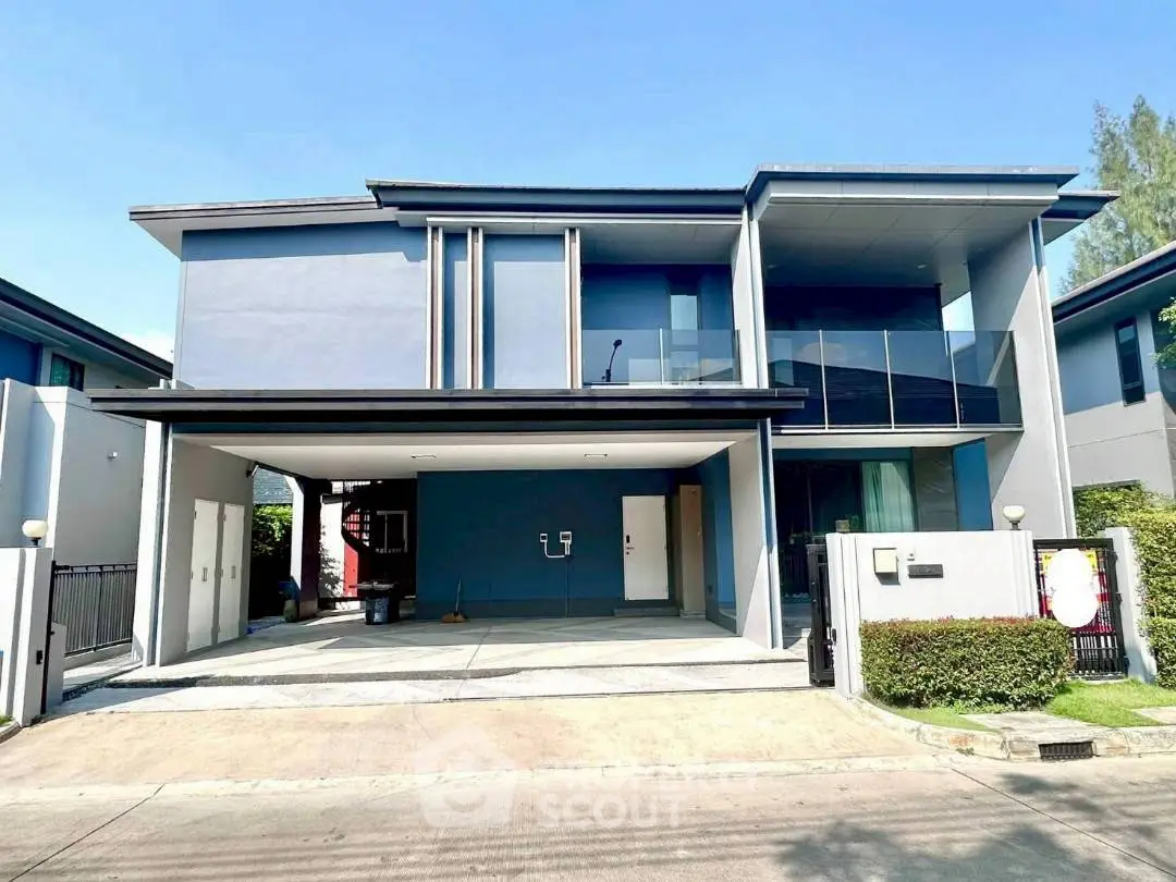 Modern two-story house with sleek design and spacious driveway