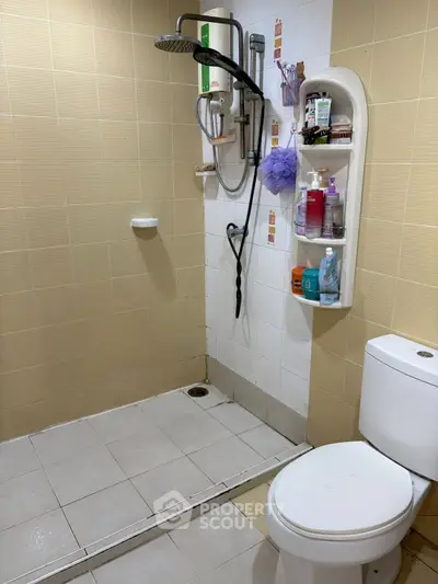 Modern bathroom with shower and toilet, featuring organized toiletries and sleek design.