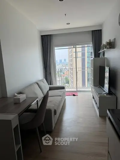 Modern living room with city view, featuring sleek furniture and natural light.