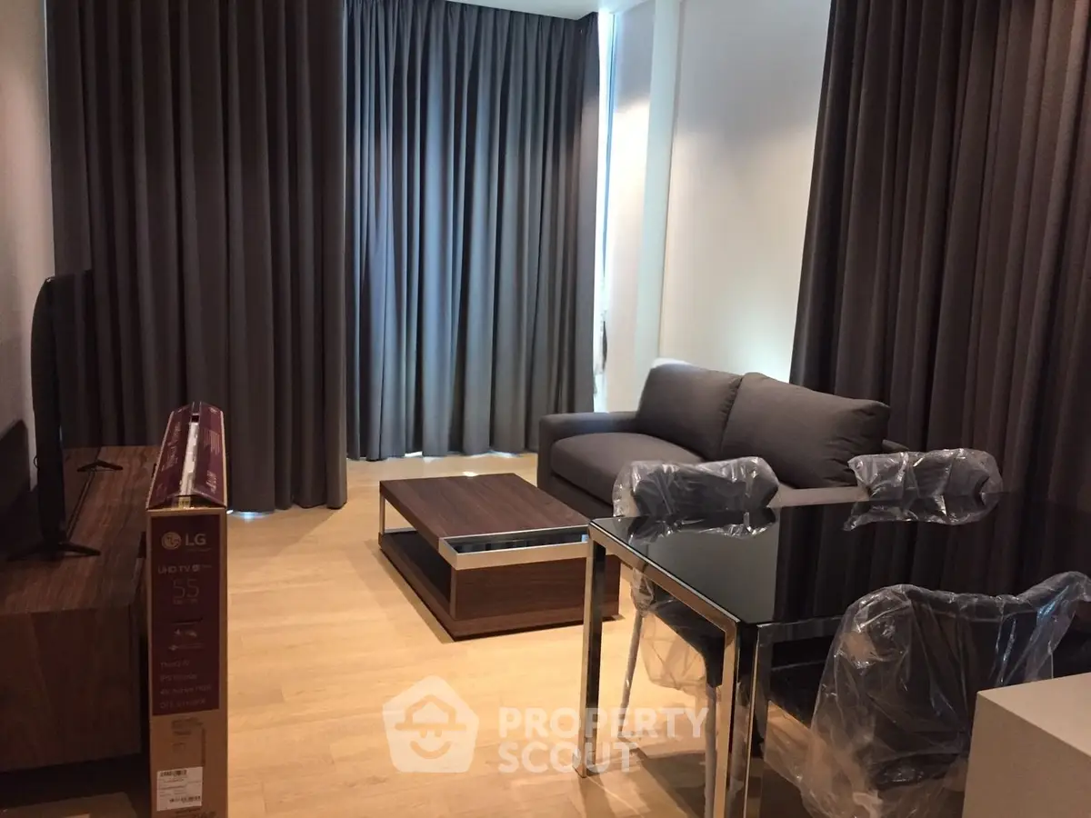 Modern living room with sleek furniture and large windows, perfect for urban living.