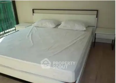 Spacious bedroom with modern bed and natural light