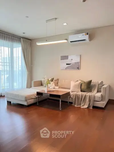 Spacious living room with modern decor and large windows