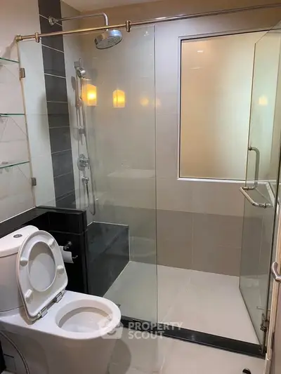 Modern bathroom with glass shower enclosure and sleek fixtures