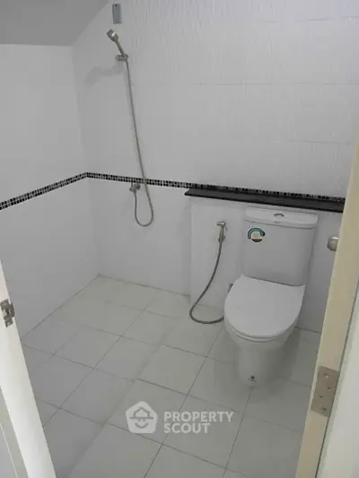 Minimalist bathroom with white tiles and modern fixtures