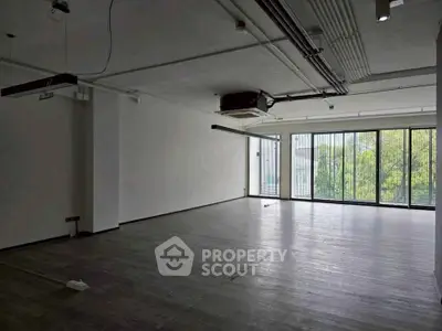 Spacious modern living room with large windows and sleek flooring