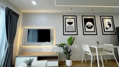 Modern living room with stylish decor, wall art, and dining area in a contemporary apartment.