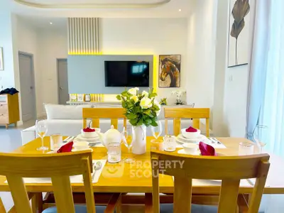 Elegant dining area with wooden table set and modern decor in a bright living room.