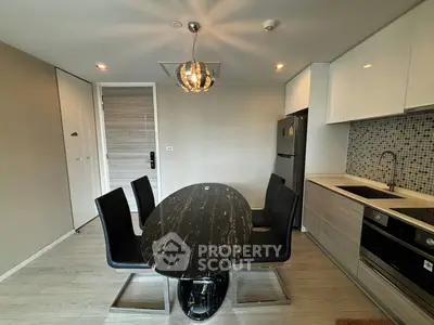 Modern kitchen with sleek dining area and contemporary lighting