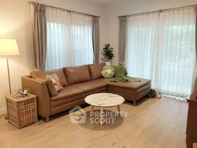 Stylish living room with brown leather sectional sofa and elegant decor