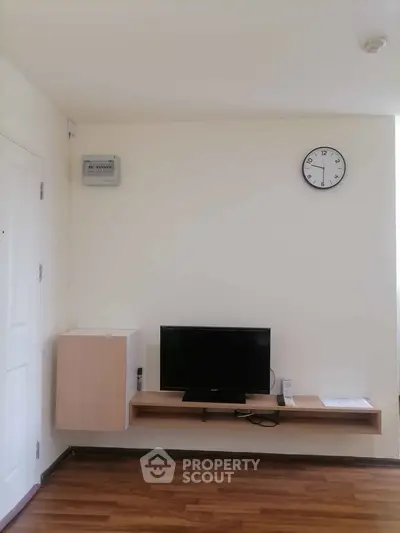 Modern living room with wall-mounted TV and minimalist decor
