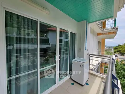 Spacious balcony with washing machine and scenic view in modern apartment